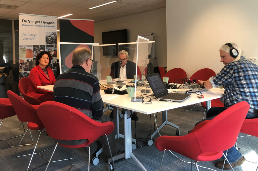 Een foto van een groep mensen in een podcast studio